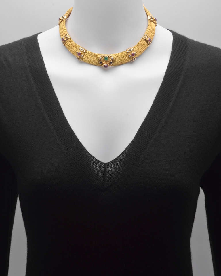 Gem-set Tudor collar necklace, designed as a woven gold collar necklace with oval-shaped cabochon-cut ruby and emerald stations with faceted round sapphire and diamond accents, mounted in 18k yellow gold, circa 1986, made in Greece, with maker's