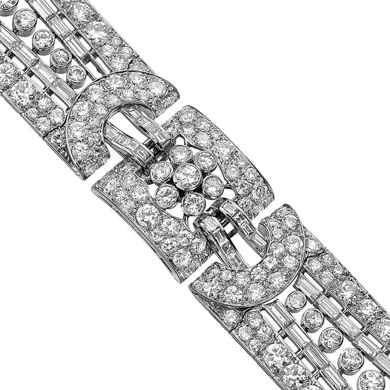 Architecturally-styled diamond link bracelet, designed with rows of baguette-cut and circular-cut diamonds meeting in a central fleurette motif of circular-cut diamonds, with 80 baguette-cut diamonds weighing approximately 8.00 total carats and 249