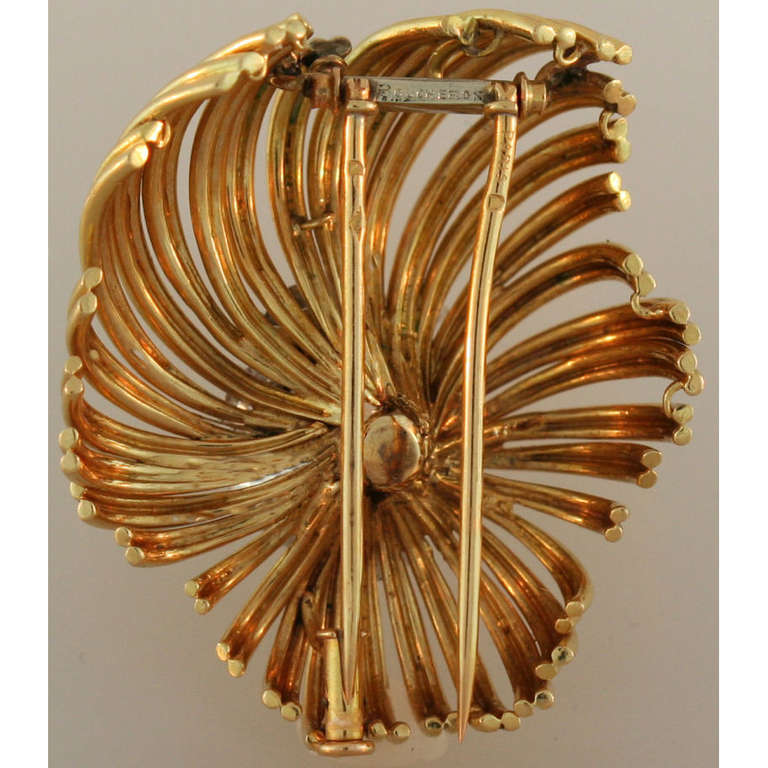 Gold wire worked flower blossom pin, centering on a cluster of seven different sized circular-cut diamonds altogether weighing approximately 4.00 carats, in 18k yellow gold, circa 1950's, signed Boucheron Paris. 1.5