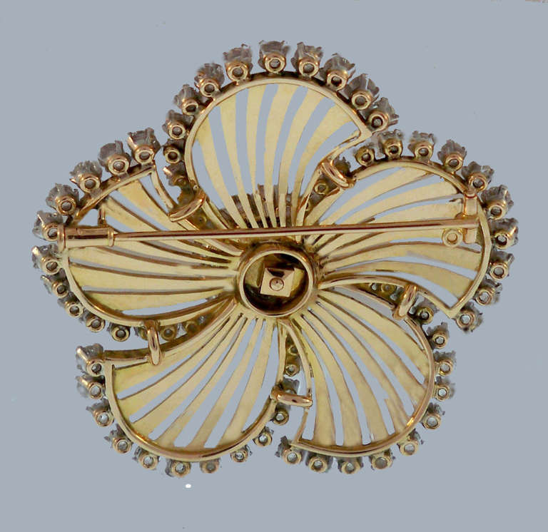 Large Japanese-style flower fan brooch, centering on a circular-cut diamond cluster to a radiating pattern in openwork 18k yellow gold to a circular-cut diamond set fringe, with 95 diamonds set in platinum and weighing approximately 10.79 total
