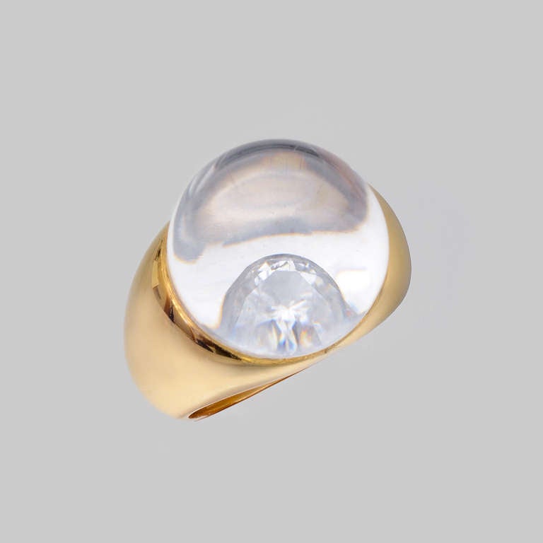 Rock crystal ball diamond ring, the rock crystal magnifying the inset round diamond at center, mounted in a wide polished 18k yellow gold setting, signed Mauboussin. Rock crystal dome measuring approximately 16mm in diameter from top. Size 5.75.