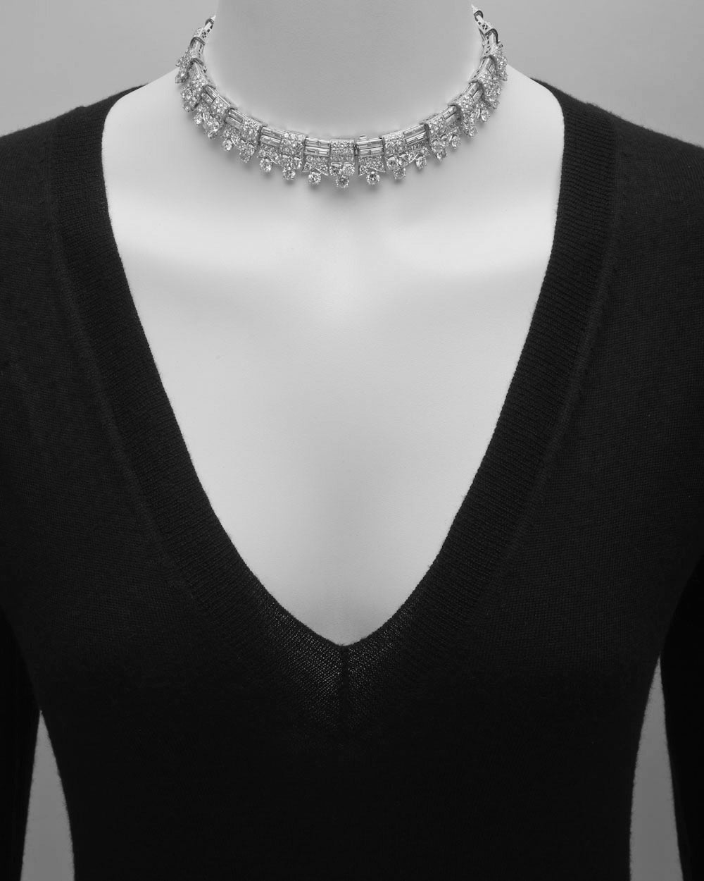 Art Deco diamond fringe necklace, of geometric design, set with approximately 45.00 totals carats of near-colorless circular-cut and baguette-cut diamonds (G-H color), mounted in platinum, with French hallmarks. 14