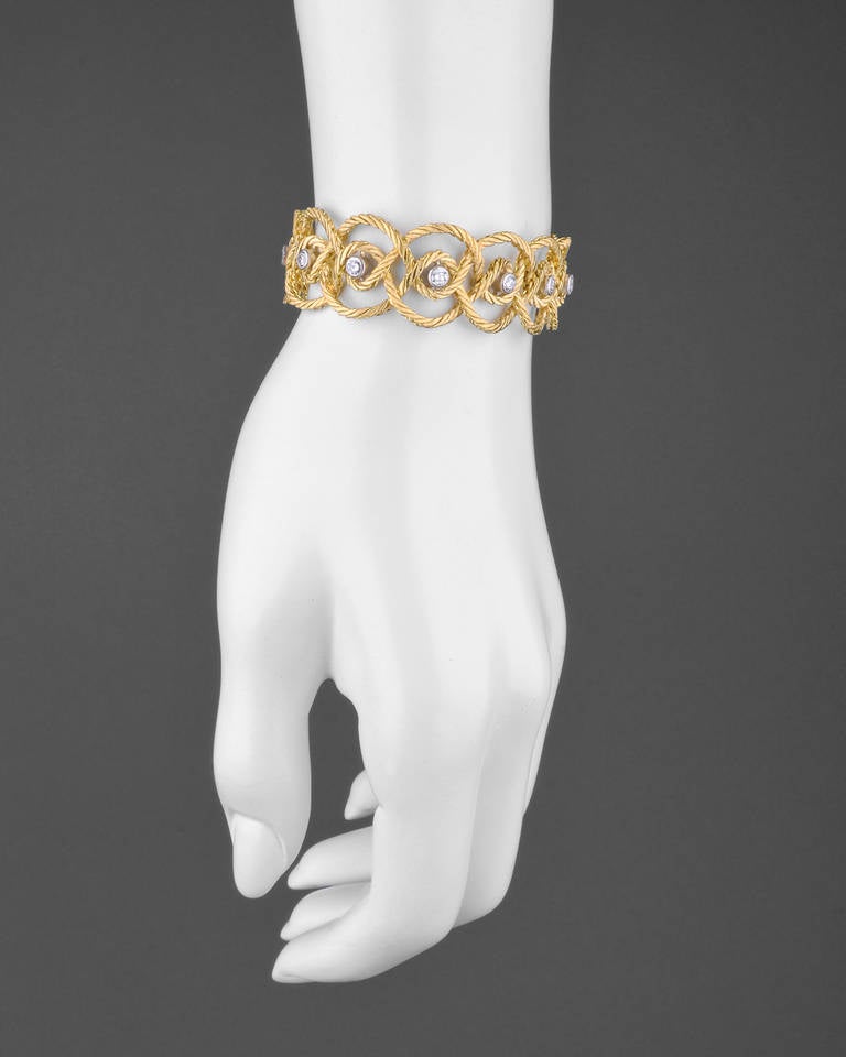 Cerchi bracelet, designed in hand-engraved woven gold rope, centering on twelve full-cut round diamonds at center, the diamonds bezel-set in white gold mounts and weighing approximately 1.40 total carats, the bracelet mounted in 18k yellow gold,