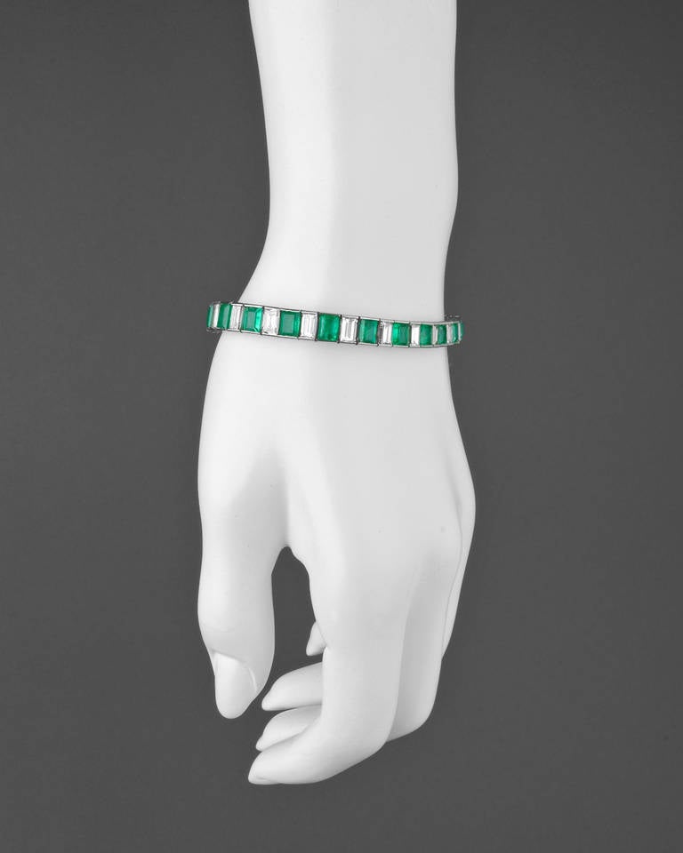 Emerald and diamond tapering line bracelet, composed of channel-set alternating rectangular-cut emeralds and diamonds, with 24 emeralds weighing approximately 8.98 total carats and 24 diamonds weighing approximately 7.78 total carats (G