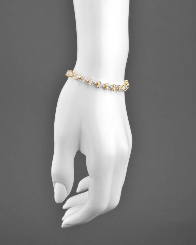 Heart-shaped diamond line bracelet, showcasing twenty-five heart-shaped diamonds weighing approximately 5.20 total carats (H-I color/VS-SI clarity), mounted in 18k yellow gold. 7