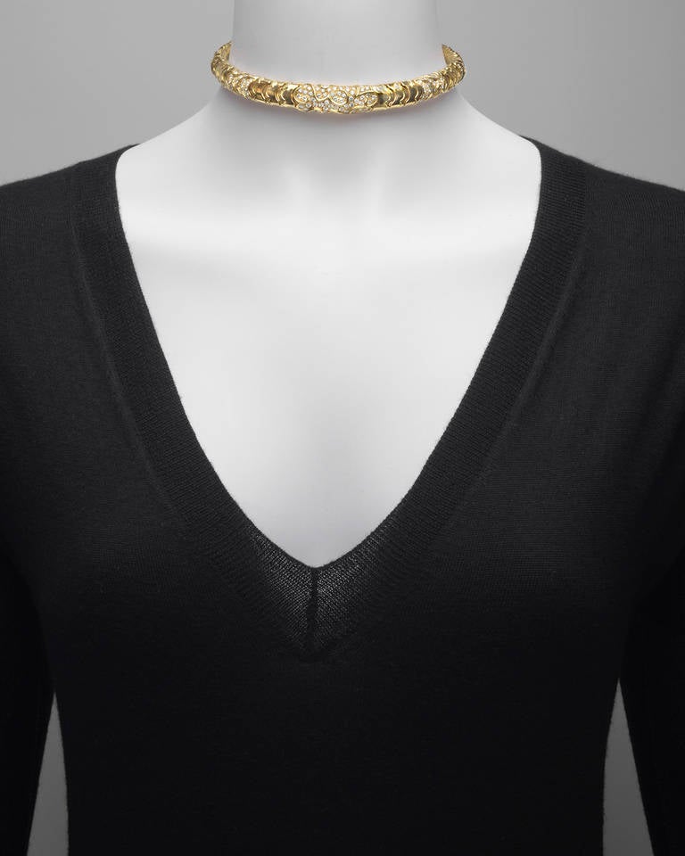 Choker necklace, designed as a flexible spring link choker in polished gold, accented by five pavé diamond sections composed of 154 circular-cut diamonds weighing approximately 6.16 total carats, mounted in 18k yellow gold, signed Marina B.