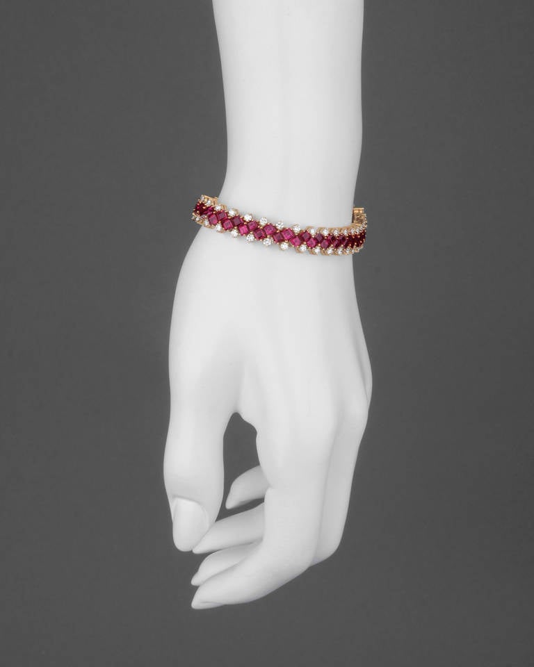 Ruby and diamond bracelet, centering on two rows of square-cut rubies, with a circular-cut diamond fringe above and below, the rubies weighing approximately 14.83 total carats and diamonds weighing approximately 3.24 total carats, mounted in 18k