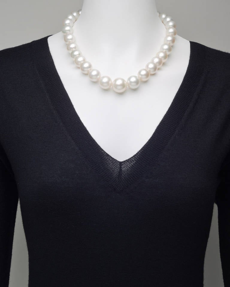 Single strand South Sea pearl necklace, composed of 31 South Sea cultured pearls, ranging from 13.8-18.9mm in diameter, strung on a silk cord, with a pavé diamond ball clasp, set with approximately 6.91 total carats of diamonds and mounted in