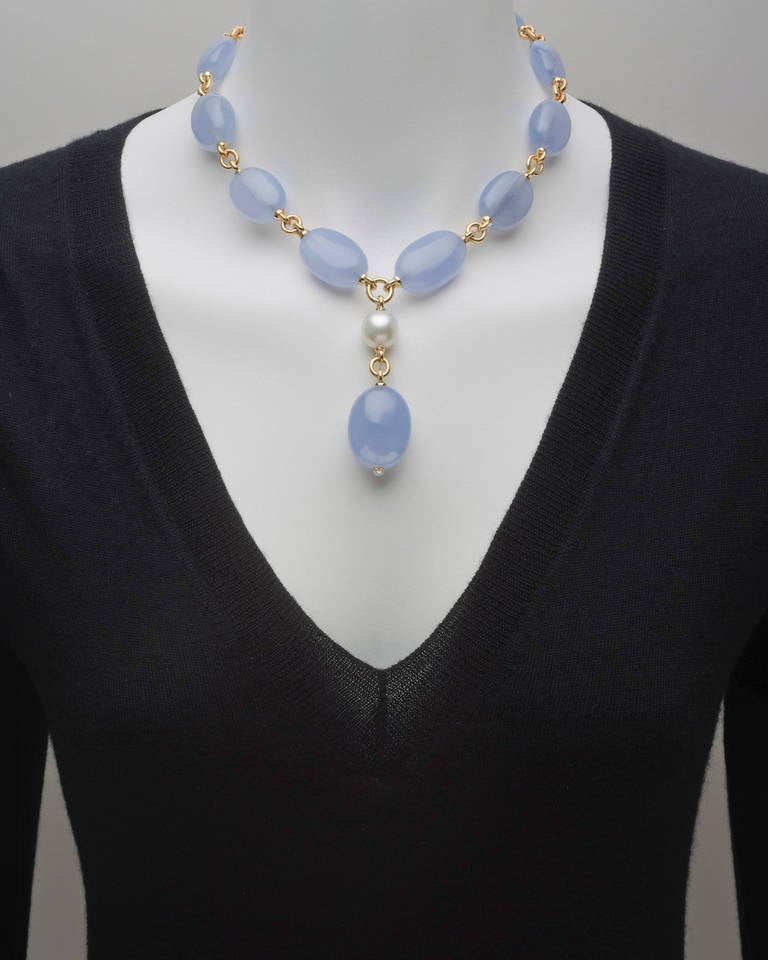 Chalcedony and South Sea pearl 'Y' necklace, composed of ten polished oval-shaped chalcedony beads connected by 18k yellow gold links with a pendant consisting of a round South Sea pearl to a larger polished oval-shaped chalcedony bead drop, mounted