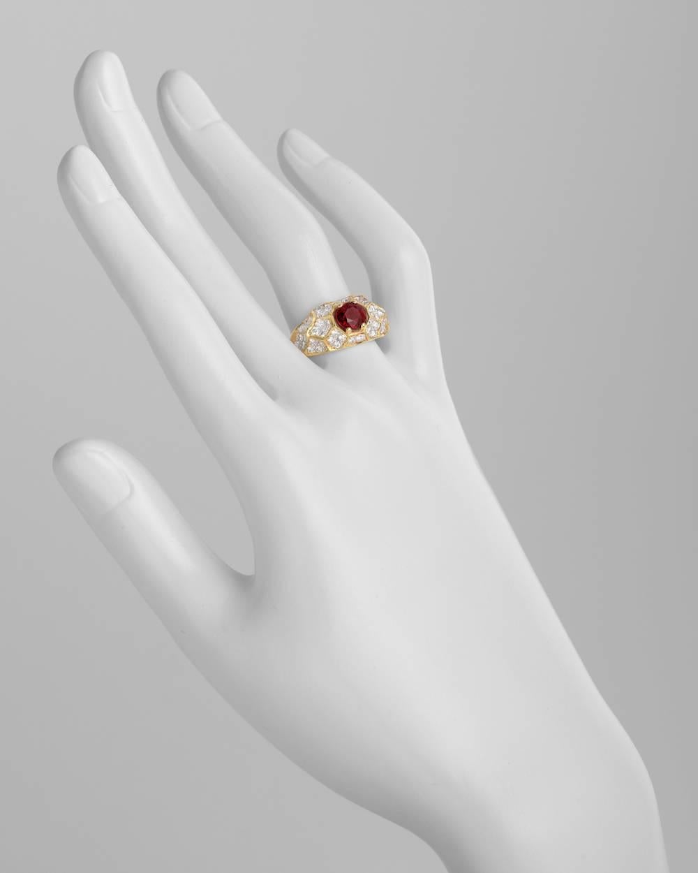 Ruby and diamond domed dress ring, centering a modified brilliant-cut ruby weighing 1.08 carats, with 52 pavé-set diamond accents weighing approximately 0.78 total carats, mounted in 18k yellow and white gold, the ring measuring approximately 10mm