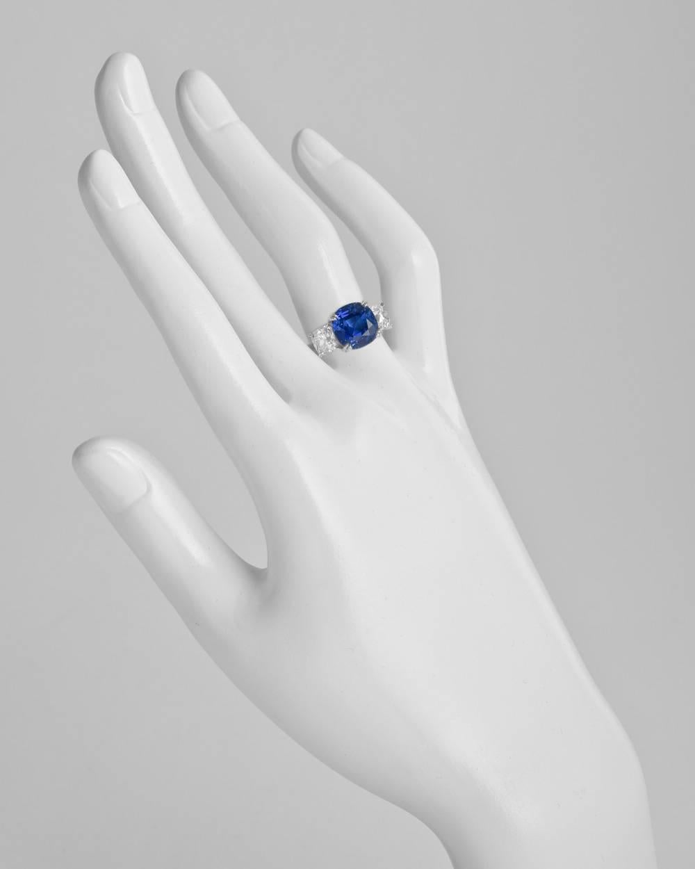 Burmese sapphire and diamond ring, centering a natural cushion-shaped sapphire weighing 7.23 carats, flanked by two near-colorless old mine brilliant cut diamonds weighing 2.00 total carats (both GIA-certified: G-H color/SI1 clarity), mounted in