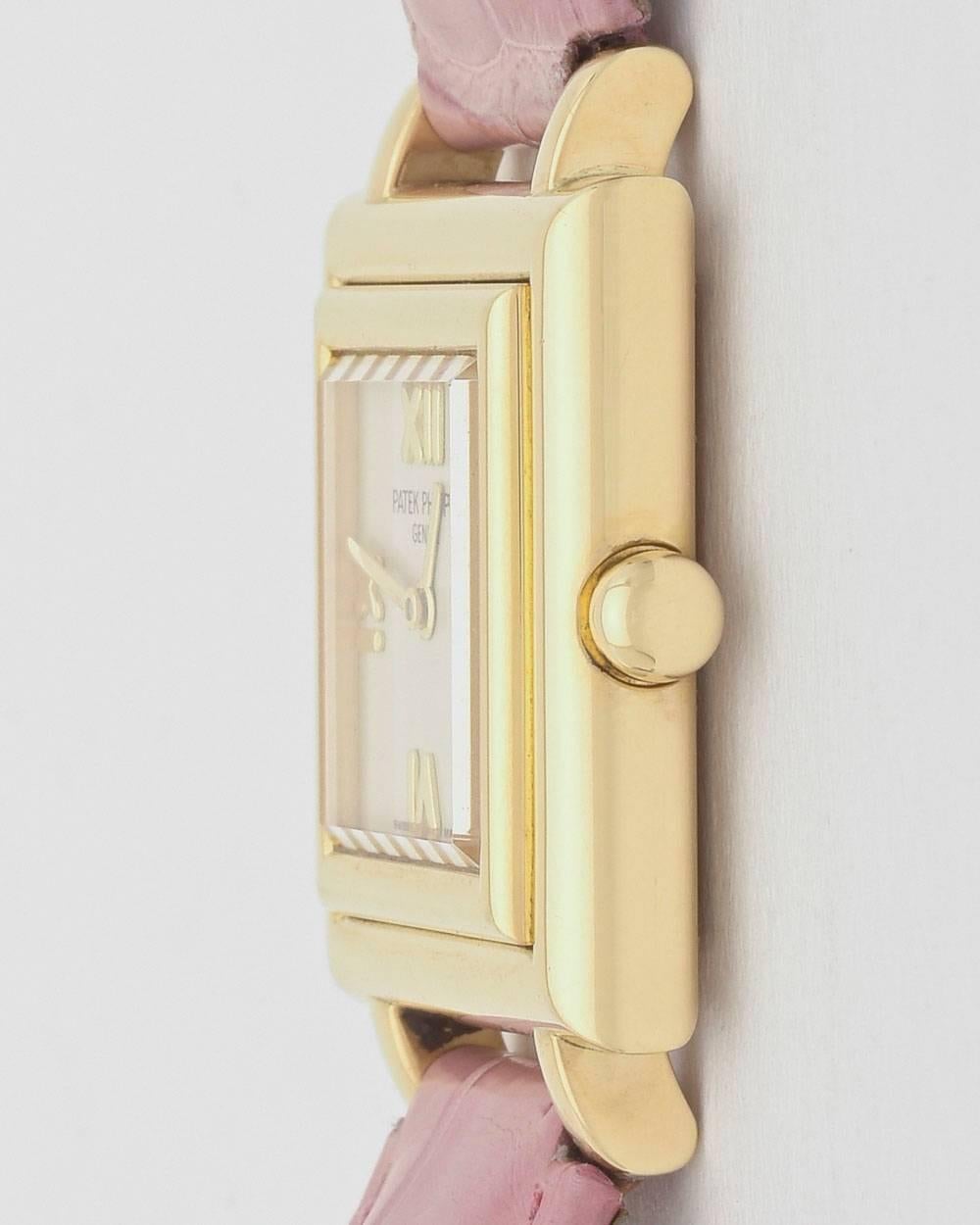Patek Philippe Ladies' Gondolo wristwatch (ref. 4866J), featuring a quartz movement; silvered dial with applied gold Roman numeral hour markers; and 25mm, square-shaped 18k yellow gold case on a pink alligator strap with an 18k yellow gold ardillon