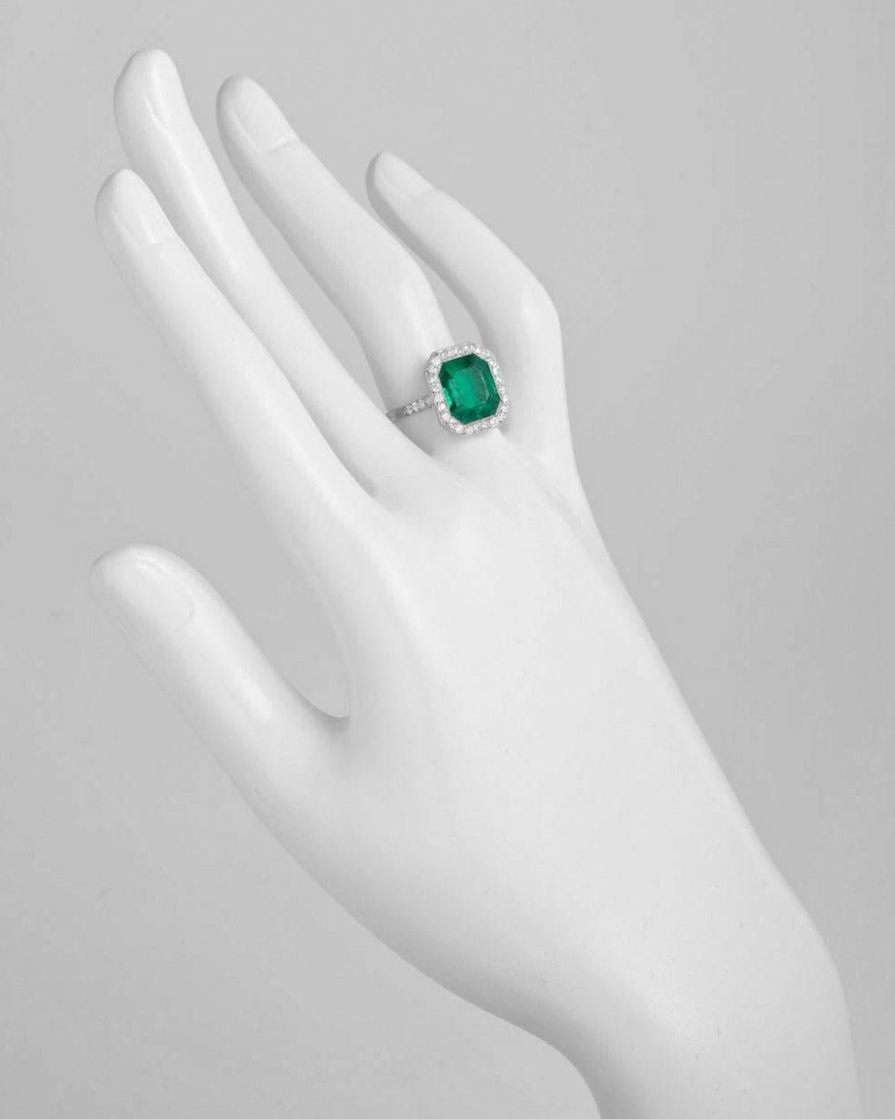 Colombian emerald and diamond ring, centering on an octagonal-shaped emerald-cut emerald weighing 3.70 carats, with diamond surround and partway bead-set diamond band, mounted in platinum, signed Tiffany & Co. Accompanied by the GIA certificate for