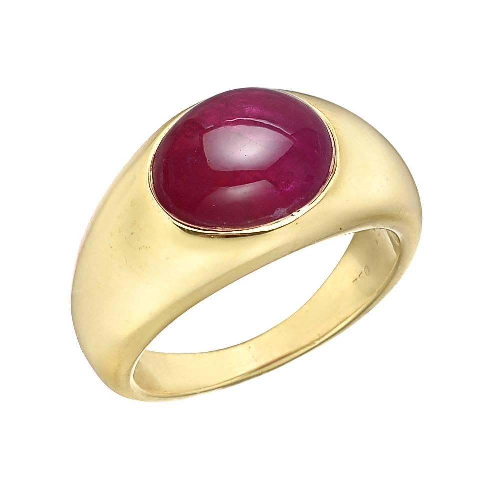 Vintage dress ring, centering a gypsy-set oval-shaped cabochon Burmese ruby weighing approximately 6 carats, mounted in a wide polished 18k yellow gold band that tapers towards the back, signed Bvlgari. Accompanied by the Bulgari ring box. Size 6.25.