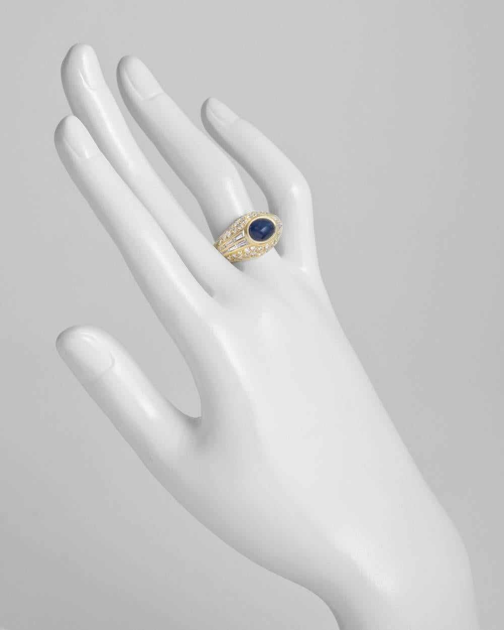 Sapphire and diamond dress ring, centering a gypsy-set natural cabochon-cut sapphire weighing approximately 3.50 carats, in a diamond-set bombé-style mounting with near-colorless round and baguette-cut diamonds weighing approximately 1.30 total
