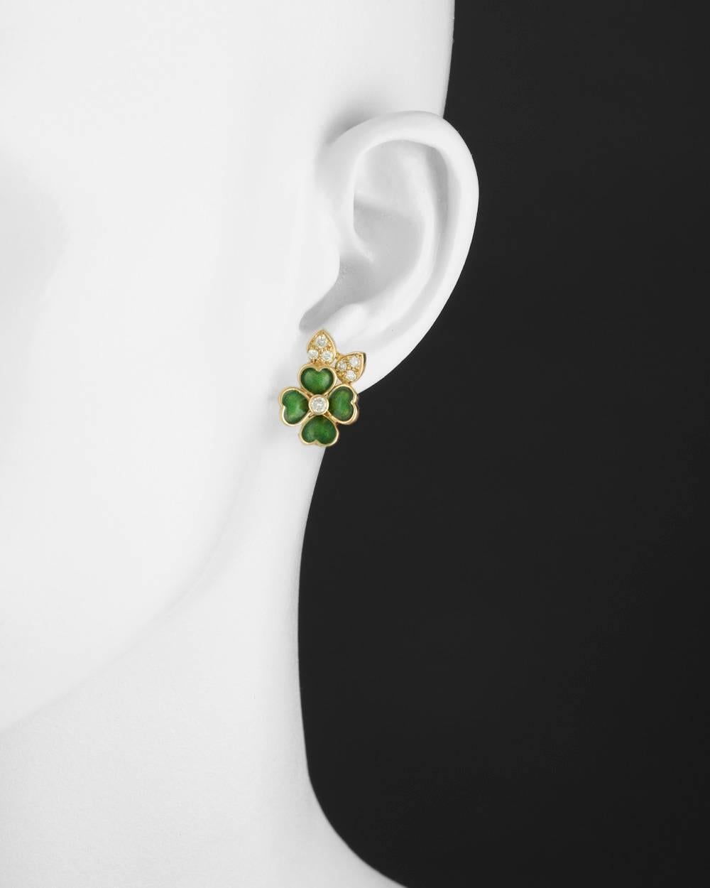 Four-leaf clover earclips, designed with two pavé-set diamond leaves astride an elegant four-leaf clover motif, the clover decorated with green enamel petals and centering a larger round diamond, with clip backs, numbered A703-914, signed