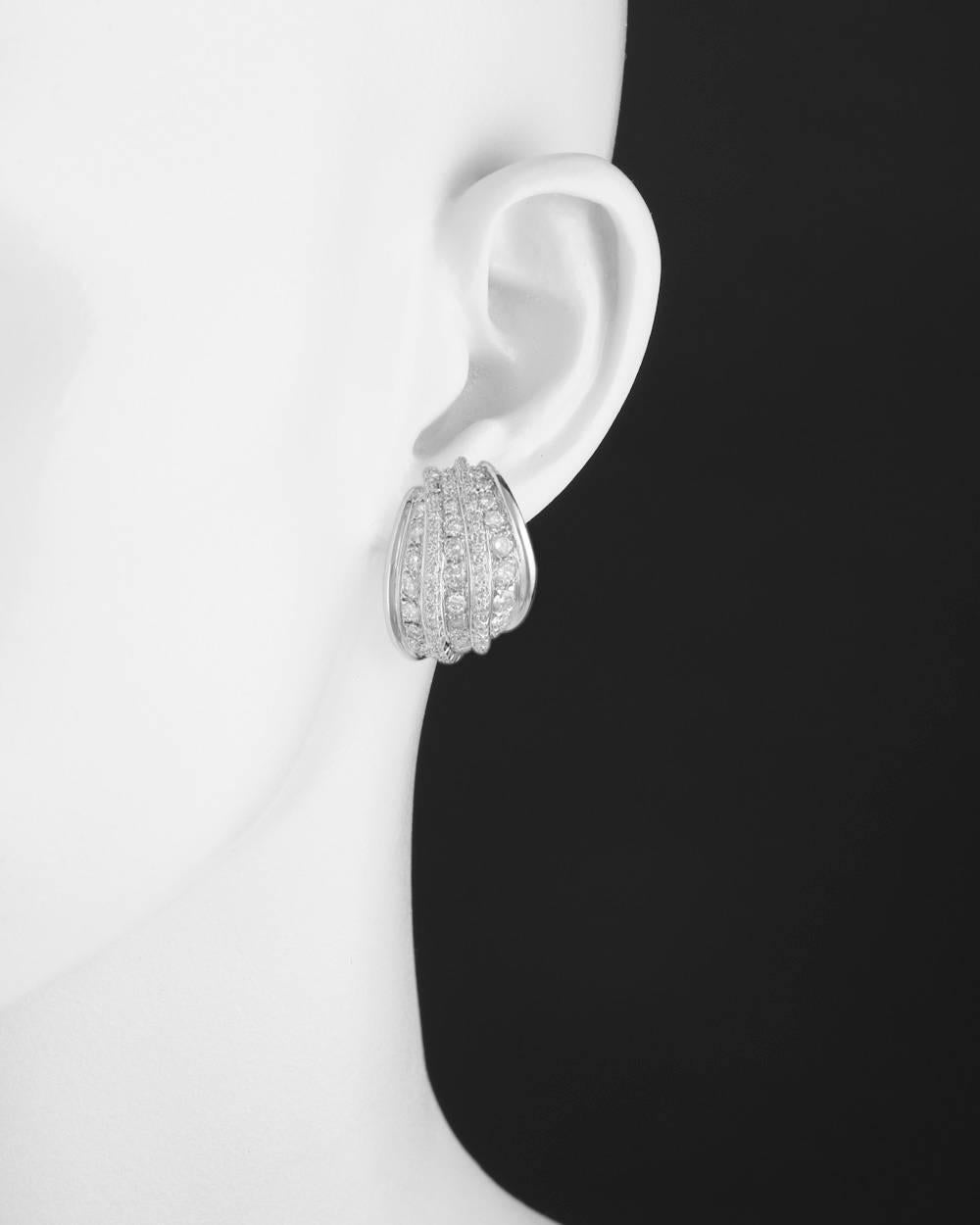 Five-row diamond earclips, designed with three rows of graduated larger round diamonds separated by two rows of smaller round diamonds, the diamonds altogether weighing approximately 3.60 total carats, mounted in 18k white gold, with clips and