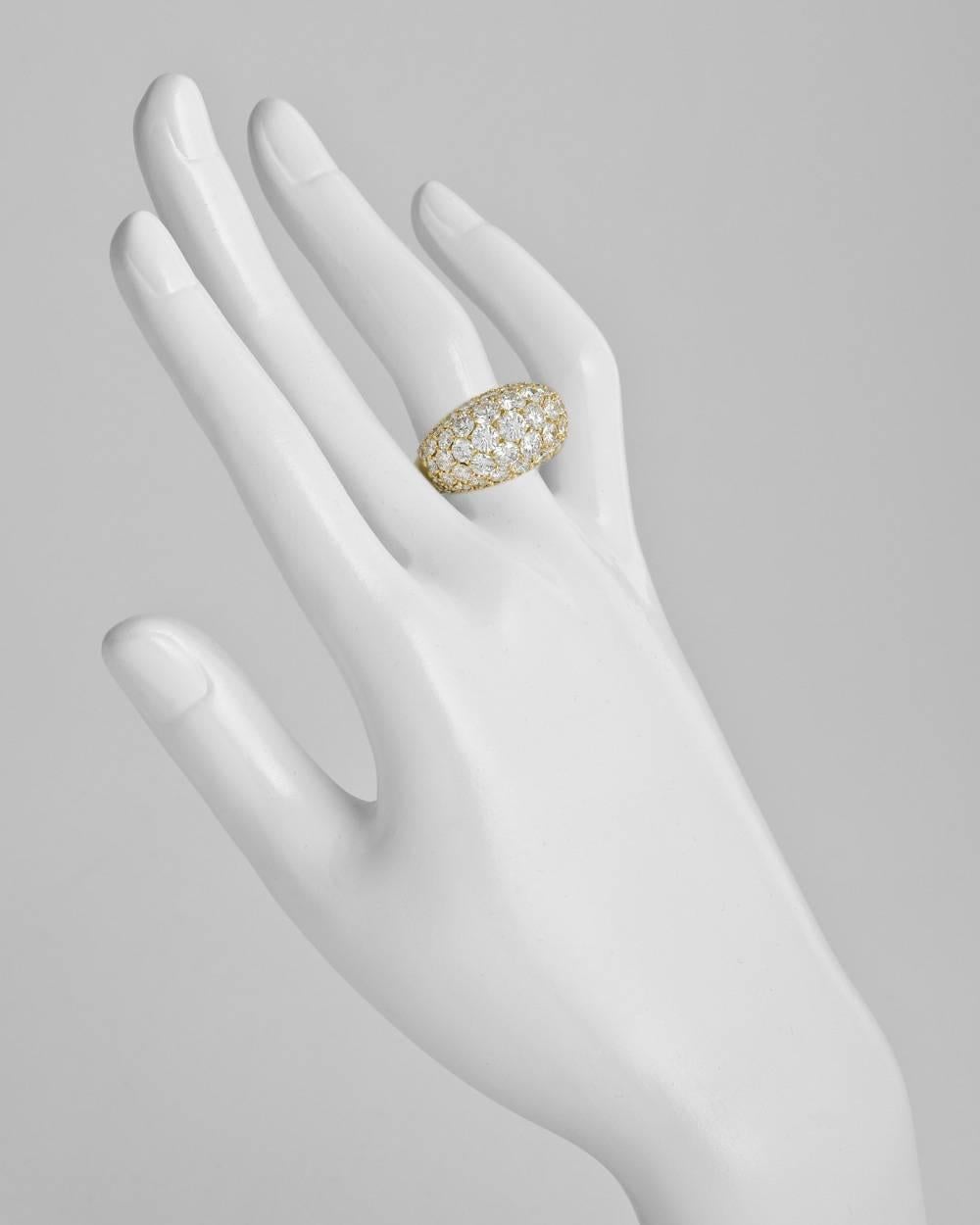 Pavé diamond dome ring, set with 75 round diamonds graduating in size and altogether weighing approximately 7.00 total carats, the ring measuring 14mm across at the widest point and tapering to the base, mounted in 18k yellow gold, numbered 143404,