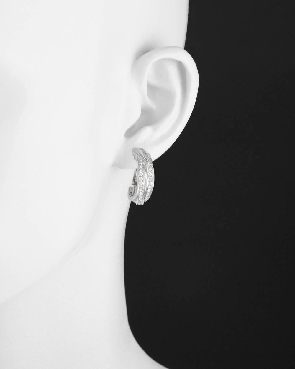 'Trinity' hoop earrings, designed as three interlocking diamond-set bands, mounted in 18k white gold, with clip backs and posts, numbered 836557, signed Cartier. High-grade round diamonds weighing approximately 1.00 total carats. 1