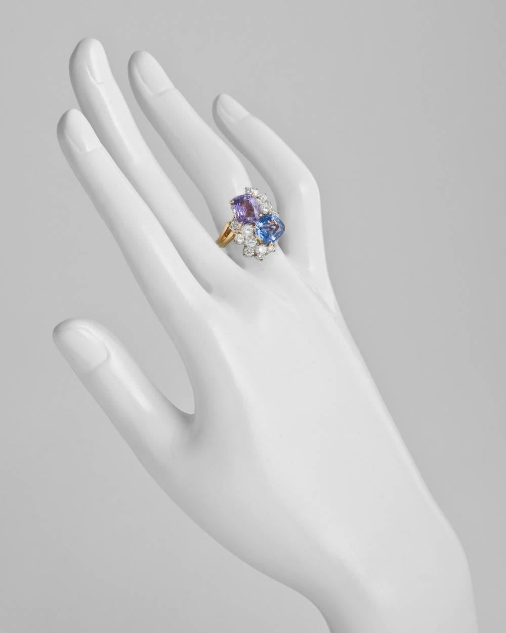 Multicolored sapphire and diamond twin ring, centering on a cushion-shaped blue sapphire weighing approximately 2.45 carats and a cushion-shaped purple sapphire weighing approximately 2.58 carats, accented by a circular-cut diamond cluster on either
