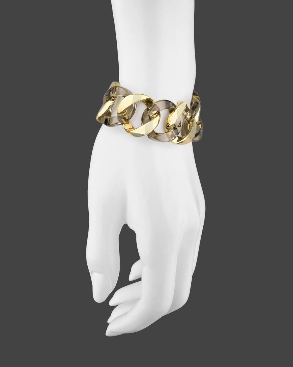 Curb-link bracelet, designed with alternating high-polished 18k yellow gold links and carved smoky quartz links, signed Verdura. 7.5