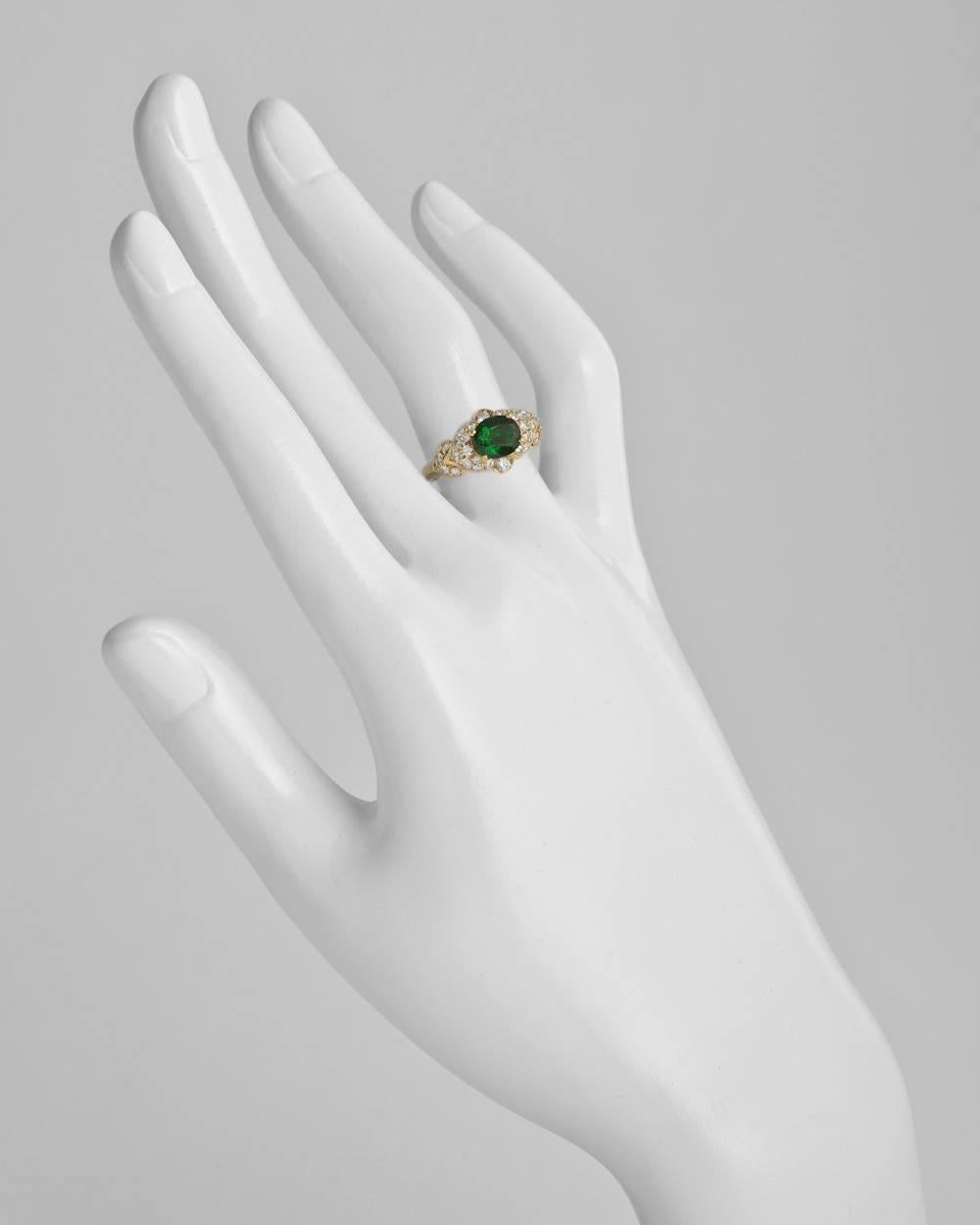 Tsavorite and diamond dress ring, centering on an oval-shaped tsavorite garnet weighing approximately 1.37 carats, with 'stepped' diamond-set surround and shoulders, the 32 round diamond accents weighing approximately 0.64 total carats, mounted in