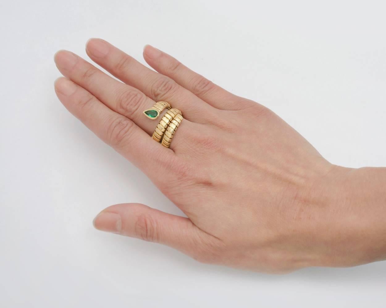 "Tubogas" three-row wrap ring, in high-polished 18k yellow gold with a pear-shaped emerald on one end, stamped 'BVLGARI'. Slightly flexible, so it fits a size 6.25-6.5 comfortably.
