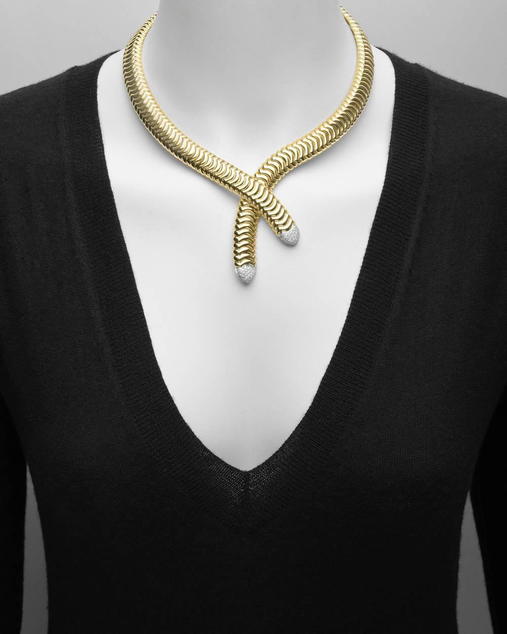 Crossover-style collar necklace in polished 18k yellow gold, the ends pavé-set with sixty near-colorless round brilliant-cut diamonds weighing approximately 0.78 total carats (G color, VVS-VS clarity), signed Garavelli. 16.5