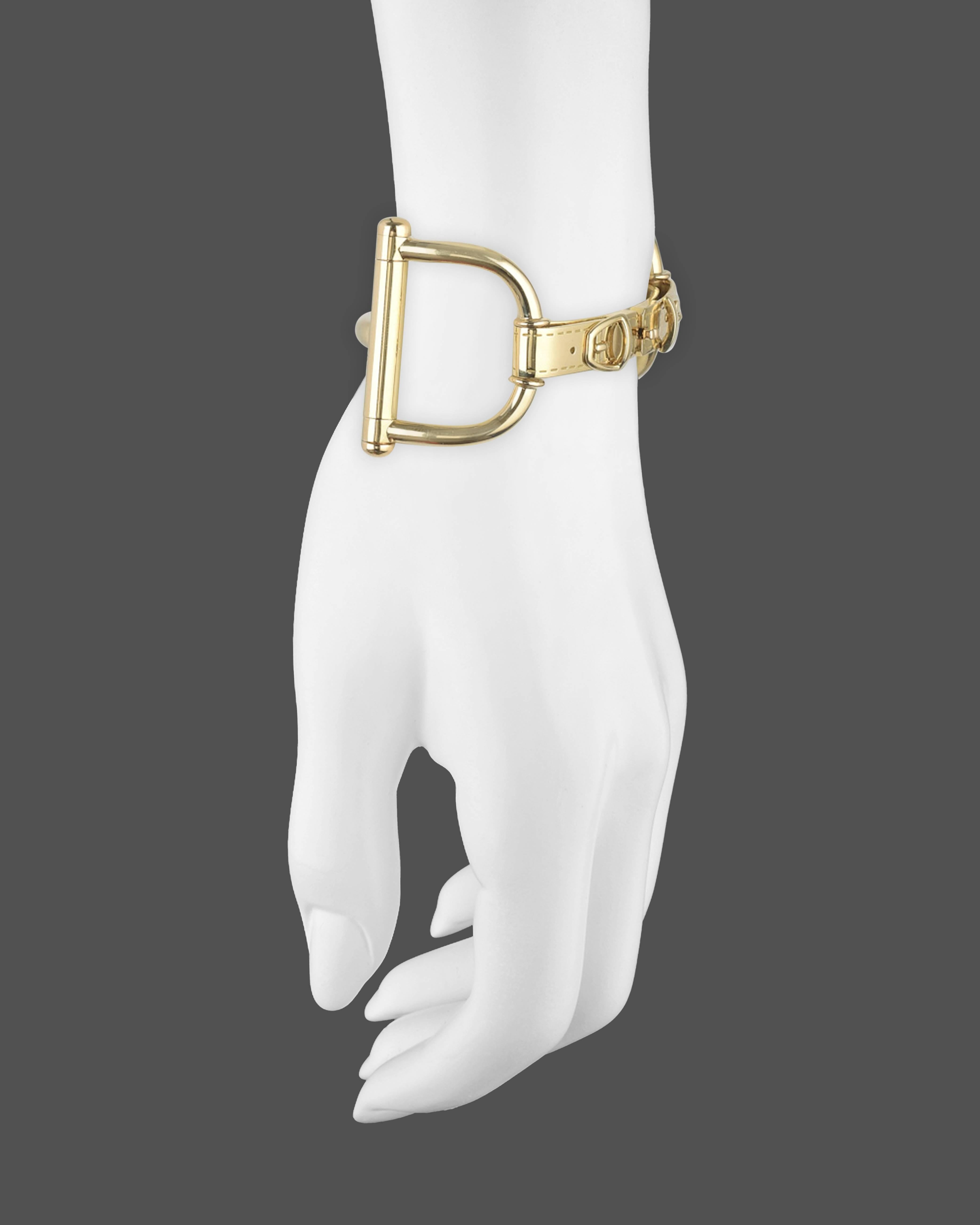 Stirrup and buckle motif link bracelet, in high-polished 18k yellow gold, signed Gucci. Size 16. 7" approximate length and 74.6 grams.
