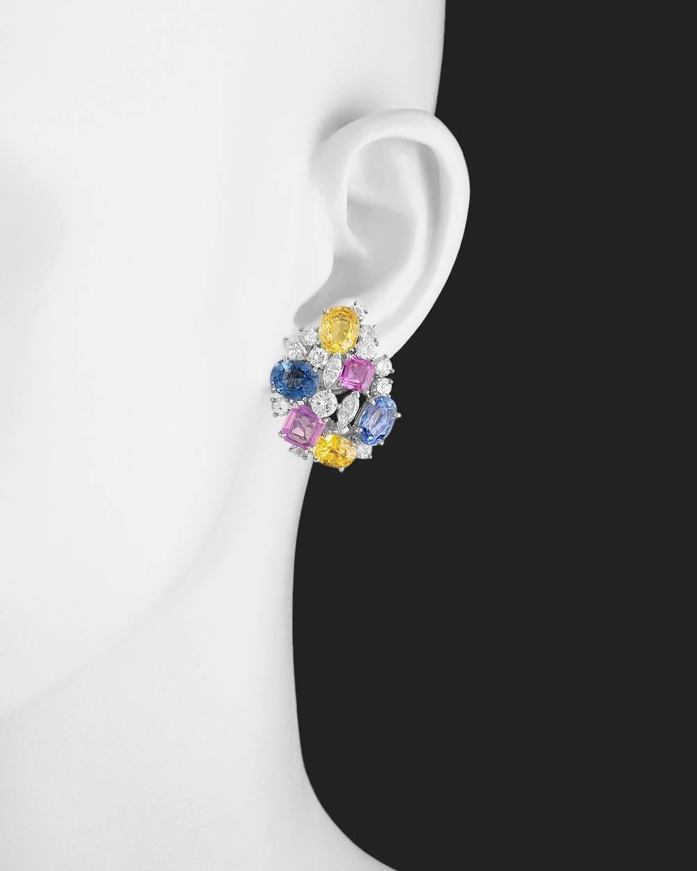 Multicolored sapphire and diamond cluster earrings, showcasing oval-shaped blue and yellow sapphires, as well as emerald-cut pink sapphires, accented by round brilliant-cut and marquise-shaped diamonds, mounted in platinum, numbered 701247 and