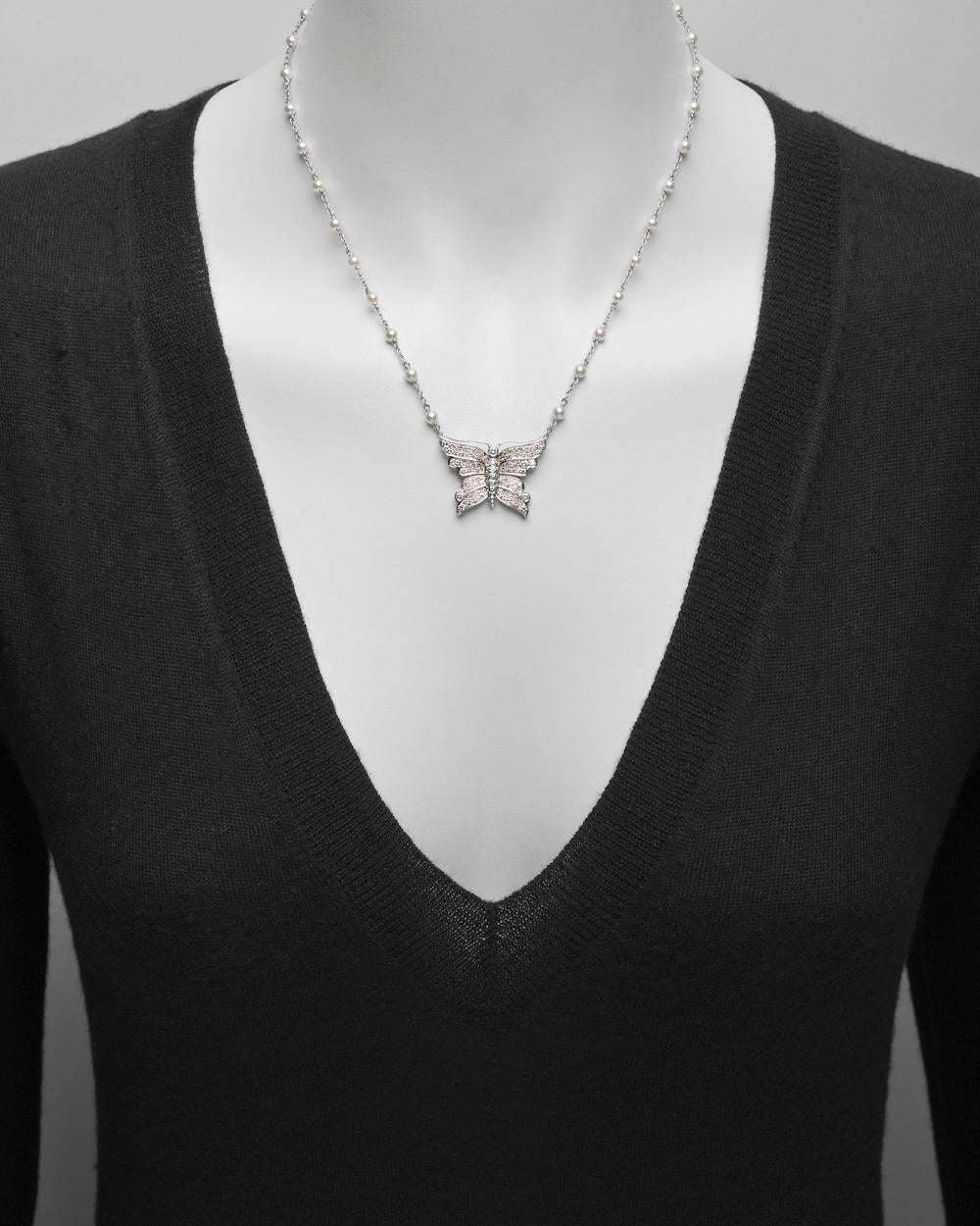 Butterfly pendant necklace, with natural light pink diamond-set wings and a white diamond-set body, in platinum, the pendant suspended from a 18" platinum chain necklace with round cultured pearl stations, signed Tiffany & Co. 72 pink