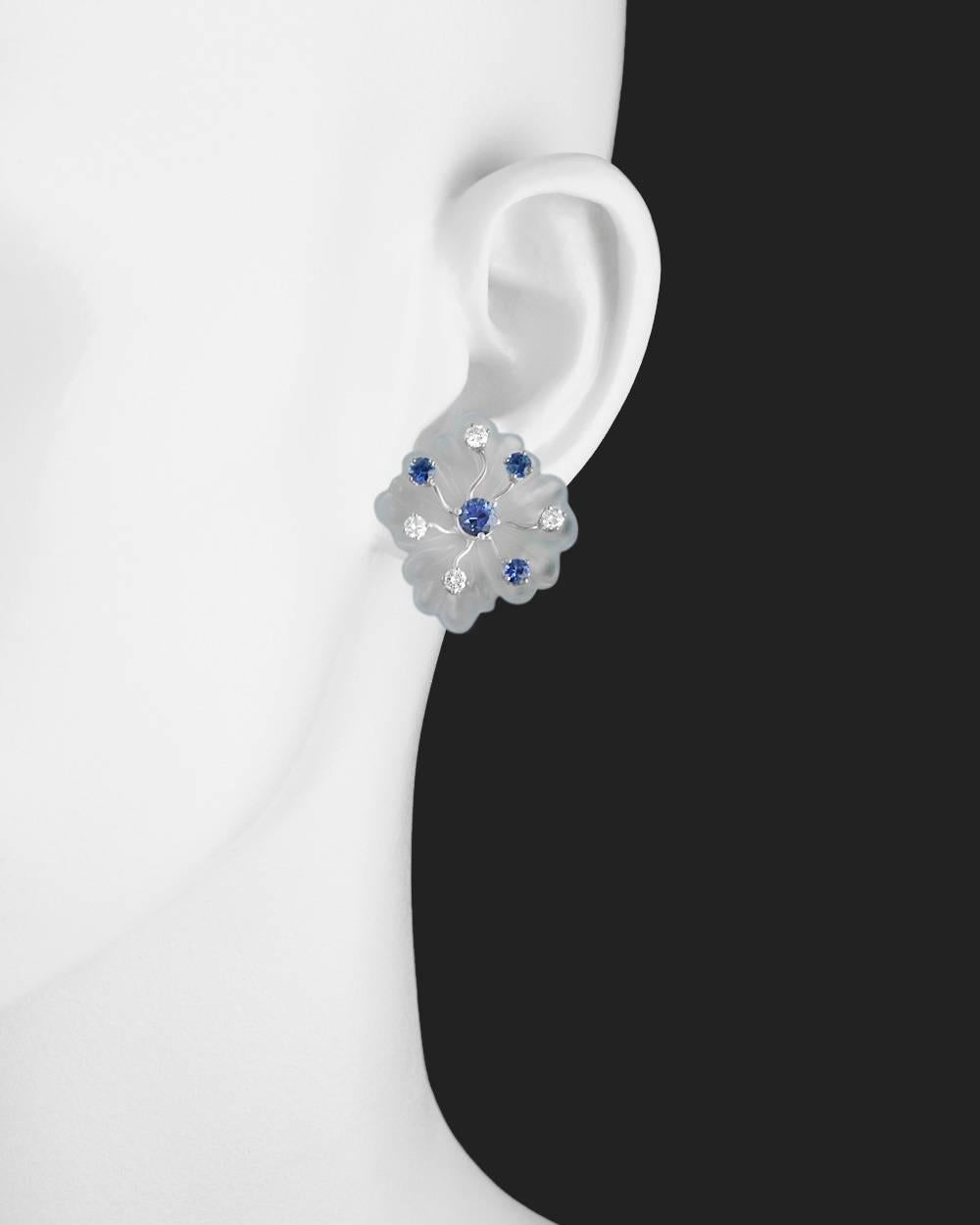 Carved chalcedony stylized flower earclips, accented by round-cut sapphires and diamond, in 18k white gold, numbered 10257 and stamped Seaman Schepps. Eight sapphires weighing 1.77 total carats and eight diamonds weighing approximately 0.80 total