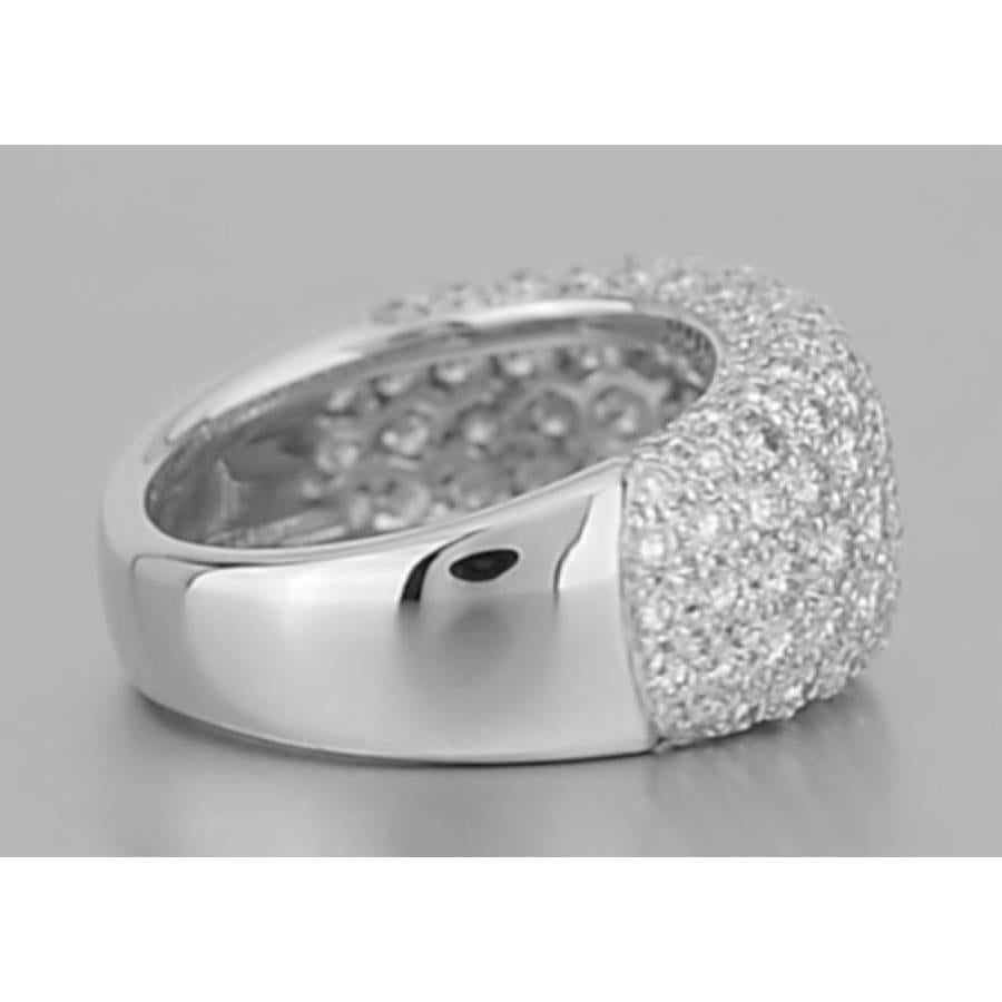 Diamond domed eternity band ring in 18k white gold, the diamonds pavé-set over halfway around the band, signed Cartier. 10.2mm band width. Size 4.5 (48 - European). This ring cannot be resized.
