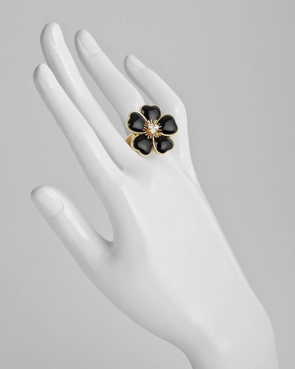 "Rose de Noel" flower cocktail ring, featuring five carved black onyx petals surrounding a cluster of three round brilliant-cut diamonds, in 18k yellow gold, numbered 'B8001 X4' and signed Van Cleef & Arpels. Size 7.
