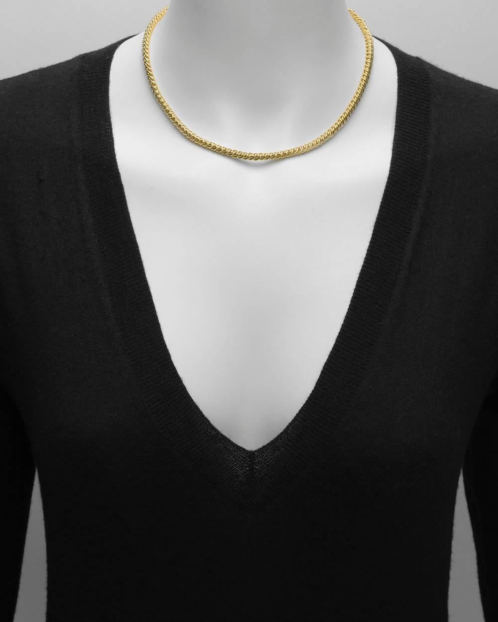 Twisted motif chain necklace in 18k yellow gold, signed Pomellato. 16.5" long and 0.15" wide (4mm).
