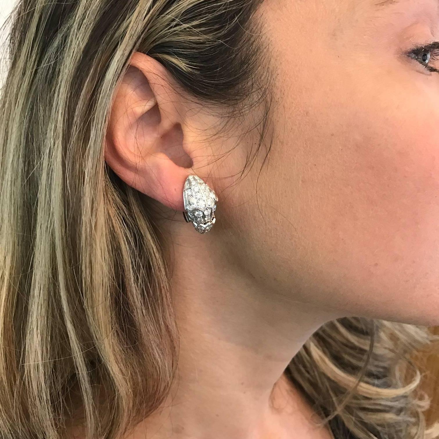 "Serpenti" earrings, designed in the classic snake motif pavé-set with round brilliant-cut diamonds and pear-shaped diamond eyes, in 18k white gold, numbered 'FGT2M1' and signed 'BVLGARI'. Clip backs. Accompanied by the original Bulgari