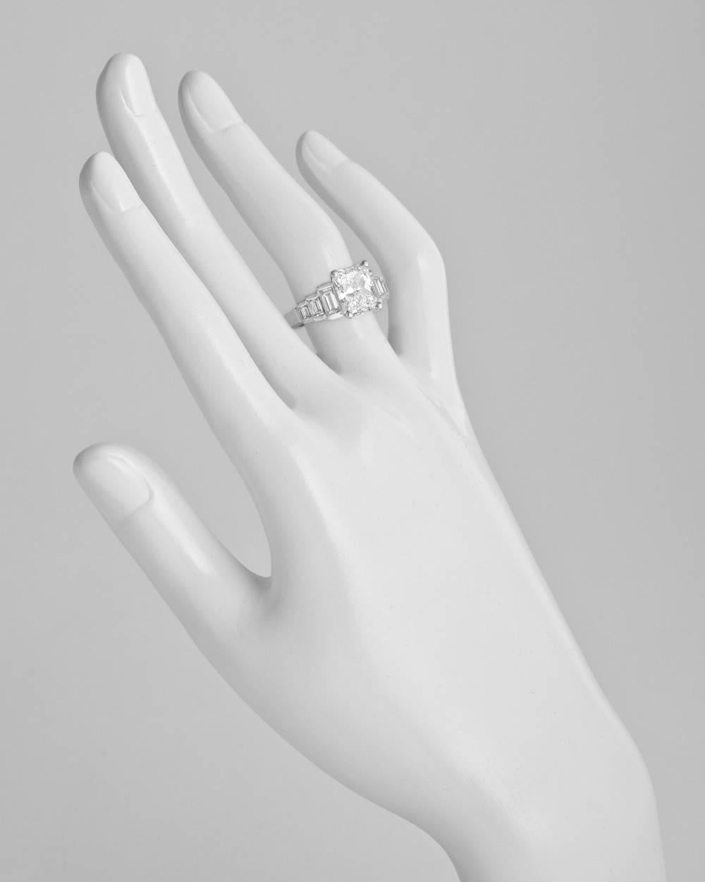 Diamond engagement ring, centering a colorless radiant-cut diamond weighing 3.00 carats (D-color/VS2-clarity), with baguette-cut diamond-set tiered shoulders, mounted in polished platinum. Accompanied by the GIA lab certificate for the radiant-cut
