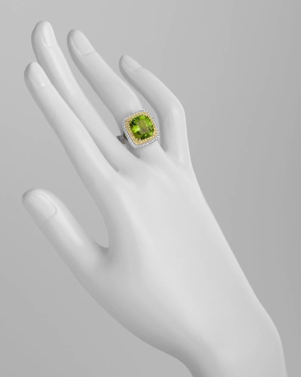 Cocktail ring, centering a cushion-shaped peridot weighing approximately 5.58 carats, within a two-tiered yellow and white diamond surround, with a pavé-set white diamond serpentine style band, the diamonds altogether weighing approximately 1.34