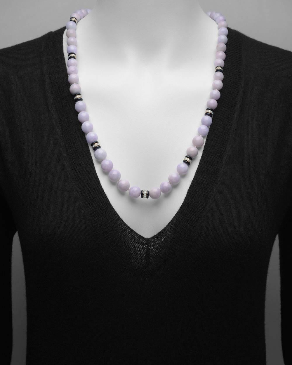 Bead necklace, composed of 57 slightly graduated lavender jade beads, ranging from approximately 10 to 13mm in diameter, with 8 black onyx and diamond-set rondelles in 18k yellow gold, with a pavé diamond ball clasp, the diamonds altogether