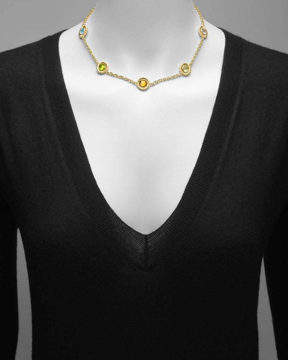 Sunflower motif station collar necklace in 18k yellow gold, composed of seven sunflower motifs with rose quartz, amethyst, blue topaz, peridot, citrine, lemon citrine and white topaz centers, the sunflower motifs approximately 14mm in diameter, on