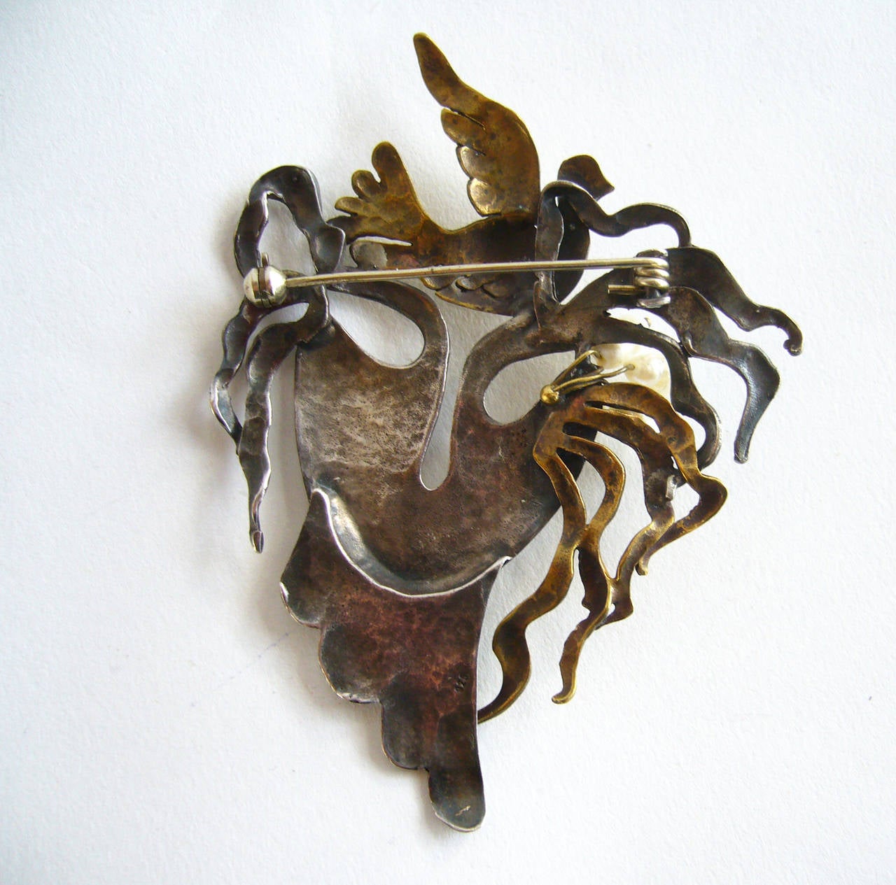 Sterling silver, brass and freshwater pearl Goddess brooch, reminiscent of Cocteau's surrealist masks, circa 1980's.  Brooch measures 3 1/2