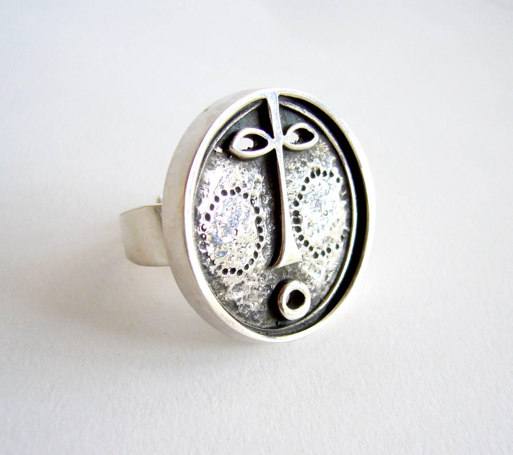 Stylized silver mask ring designed and created by Jorma Laine of Finland. Diameter of the face is about 1 1/4