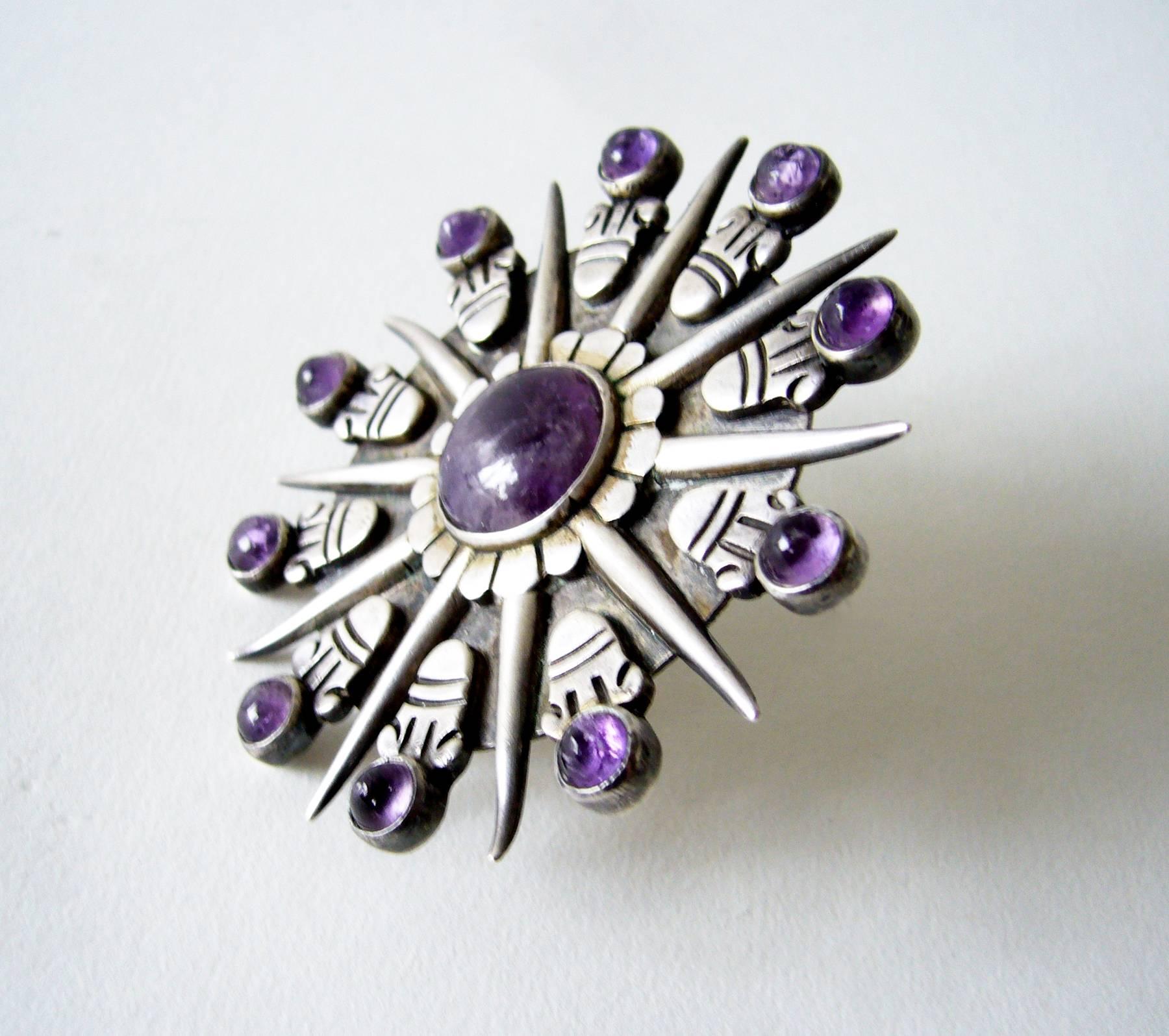 Iconic Aztec sunburst amethyst and sterling silver brooch designed and created by William Spratling of Taxco, Mexico. Brooch measures a large 3