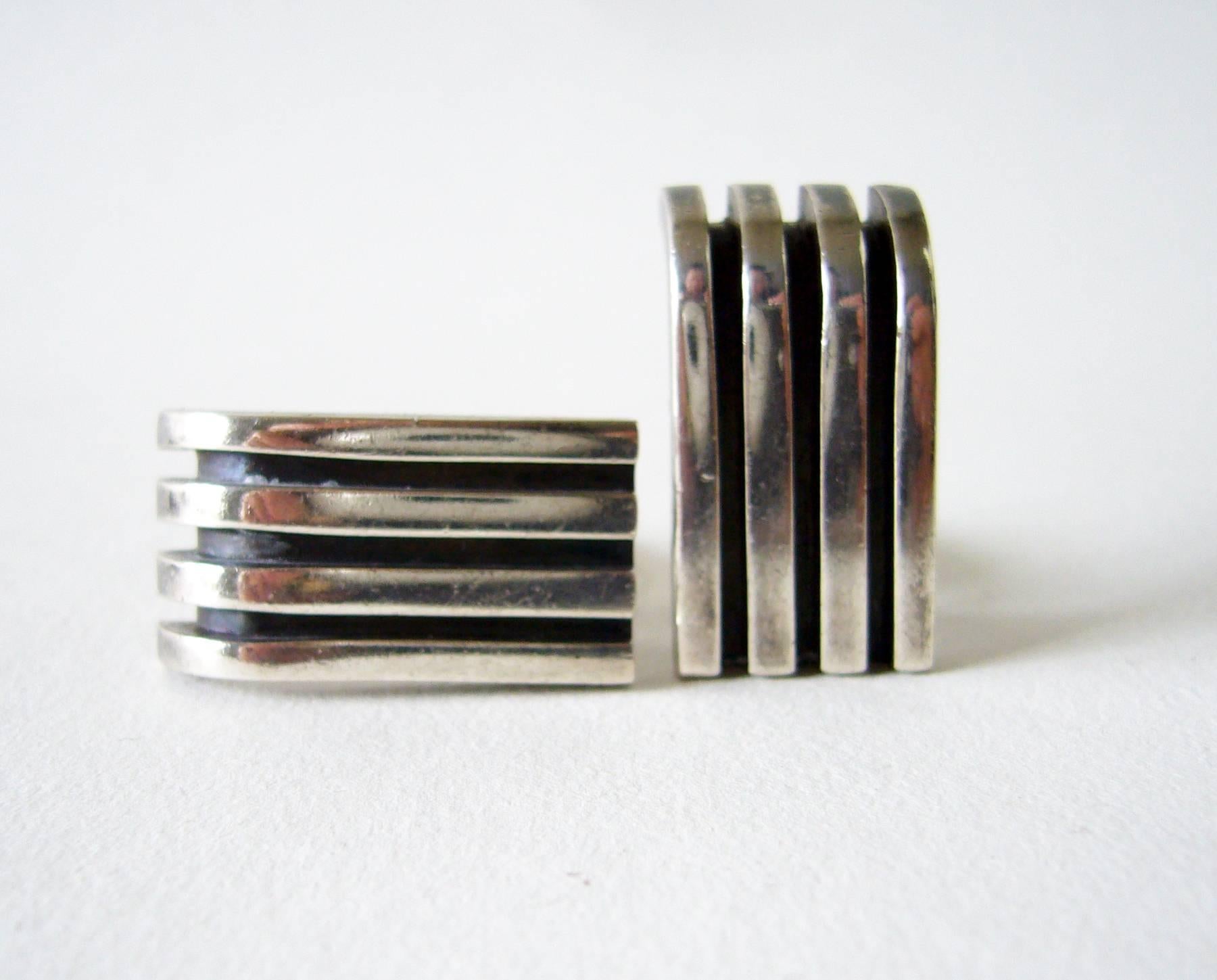 Machine age sterling silver cufflinks and tie bar set designed and created by Antonio Pineda of Mexico.  Cufflinks measure 1 1/8