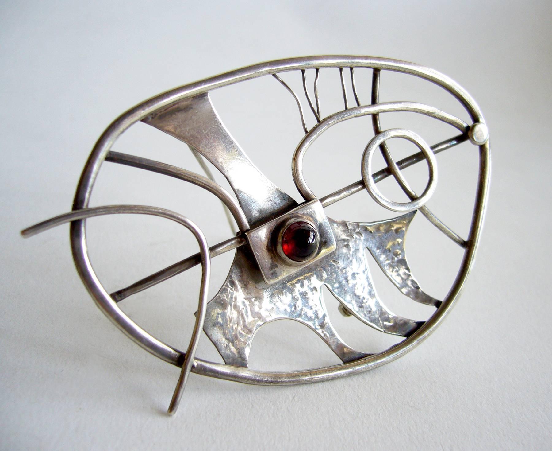 Large abstract modernist sterling silver and garnet brooch, American, circa 1950's.  Brooch measures 2.25