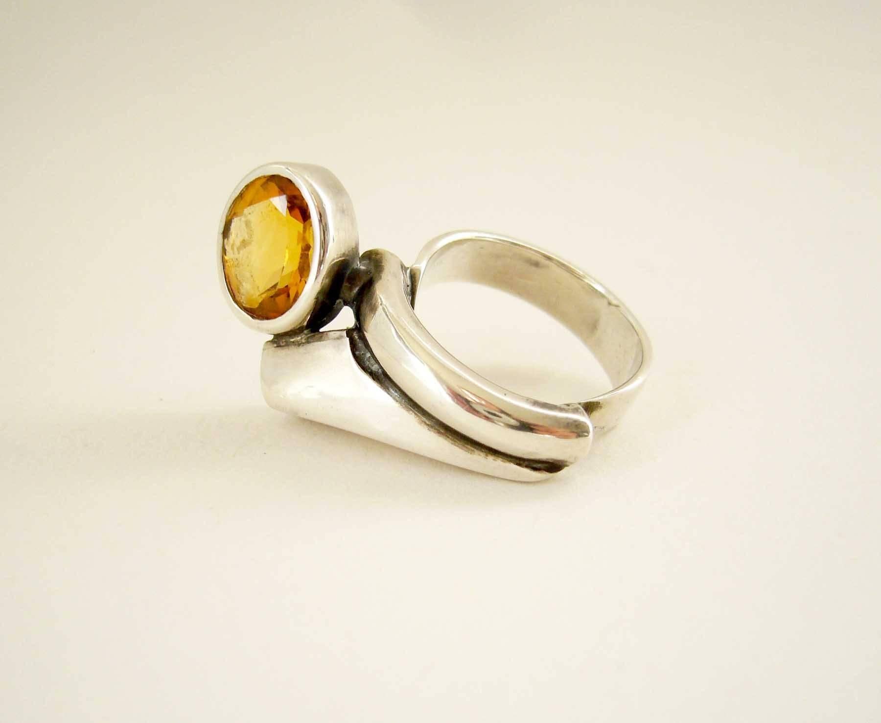 1970's sterling silver ring with faceted citrine stone created by French jeweler Suzanne Somogy.  Ring is a finger size 5 and crosses over slightly to the next finger.   Signed Somogy on on its underside and French hallmarks on the shank.  In very