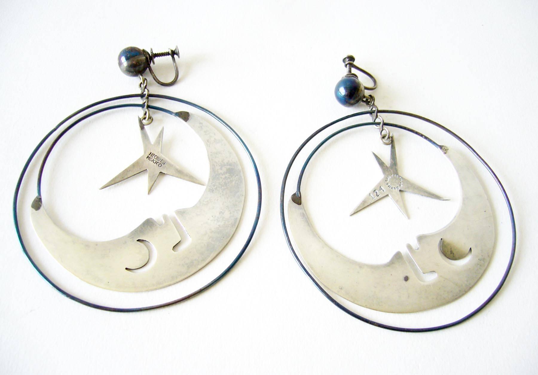 Man in the moon with stars kinetic mobile earrings created by Los Castillo of Taxco, Mexico circa 1960's.  Earrings are of the screwback variety and measure 3 5/8