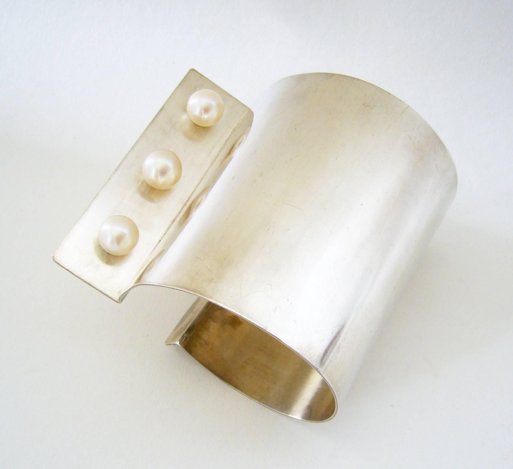 Sterling silver handmade cuff bracelet with three 12 mm south sea pearls, designed and created by Heidi Abrahamson of Phoenix, Arizona.  Bracelet is made for the left wrist and measures 3" in width with an interior circumference of 7.5". 