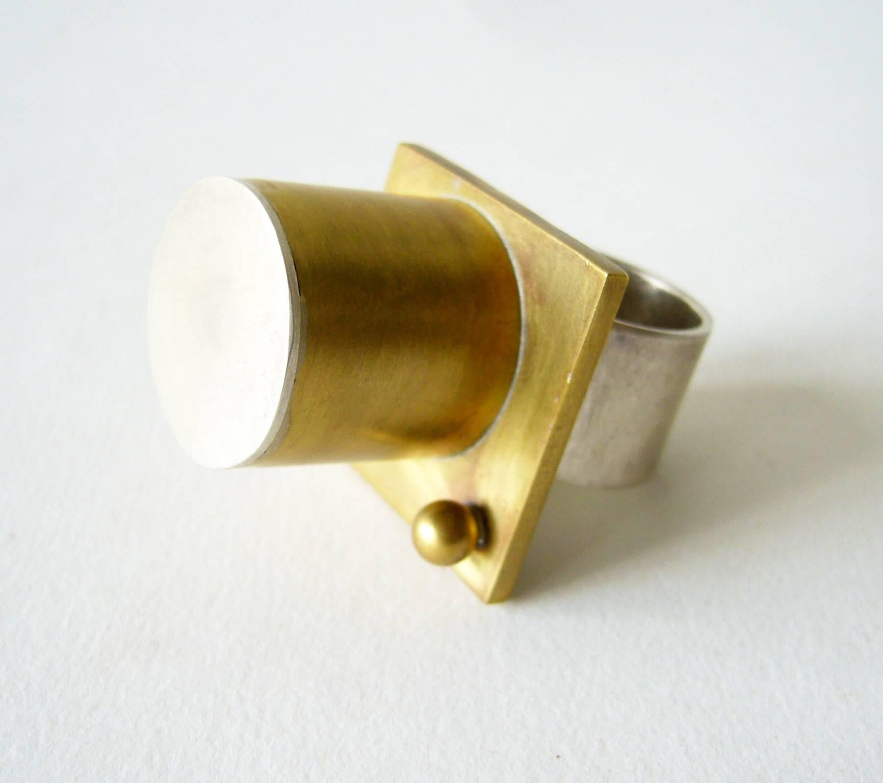 Sterling silver and brass column ring in post modernist style created by Heidi Abrahamson of Phoenix, Arizona.  Ring is a finger size 7.75 and stands .75