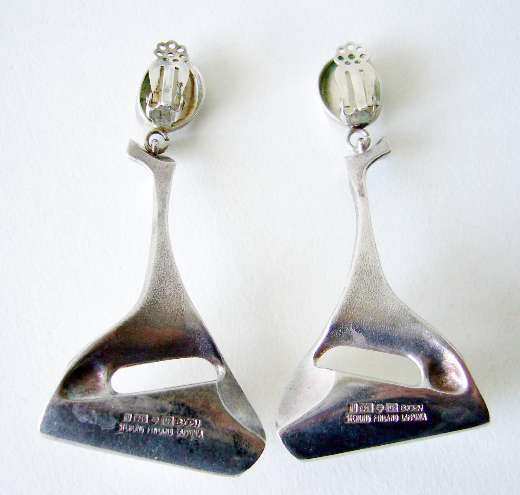 Sterling silver space age earrings created by Finland's master jeweler and sculptor Bjorn Weckstrom.  Earrings measure 3" in length by 1.25" at their widest measurement.  They are of clip back variety and have a soft matte finish to the